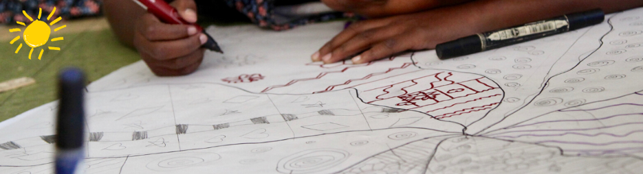 A child's hands pain with fine-point pens on a while paper