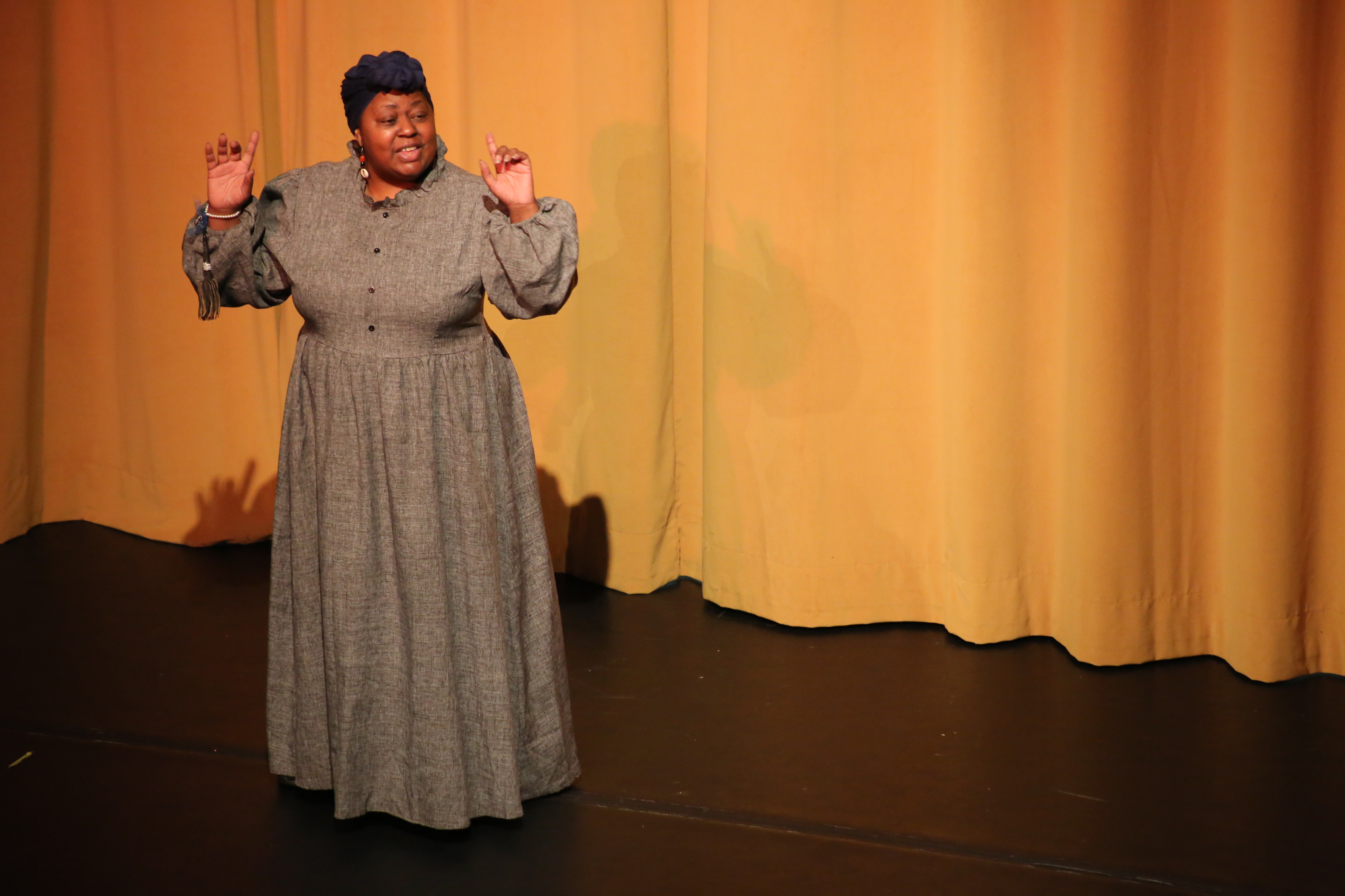 actress performs in come freedom come on stage in front of curtain