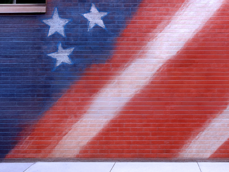 Mural showing part of American flag painted on bricks